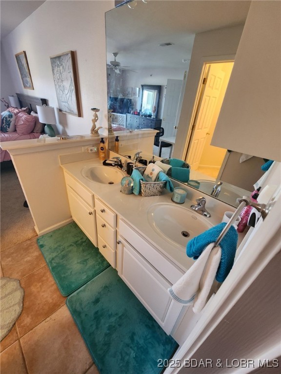 bathroom with tile patterned flooring, vanity, and ceiling fan