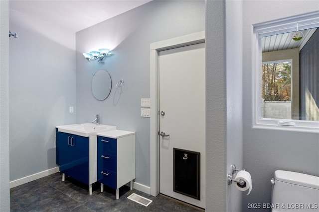 bathroom featuring toilet and vanity