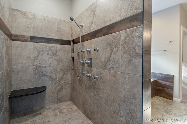 bathroom with a tile shower