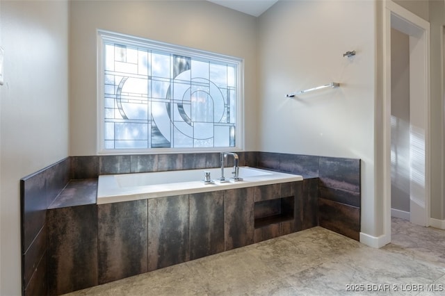 bathroom featuring tiled tub