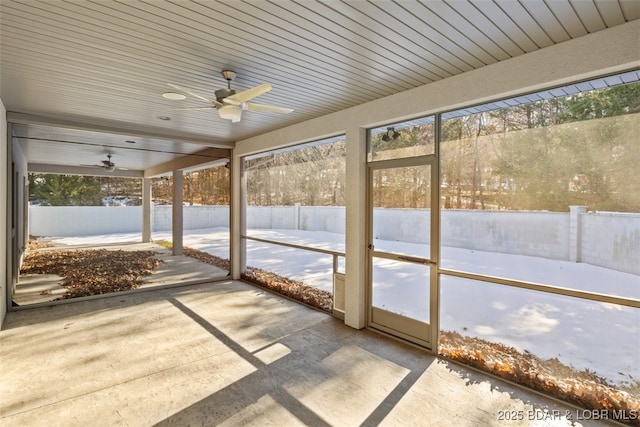 unfurnished sunroom featuring ceiling fan