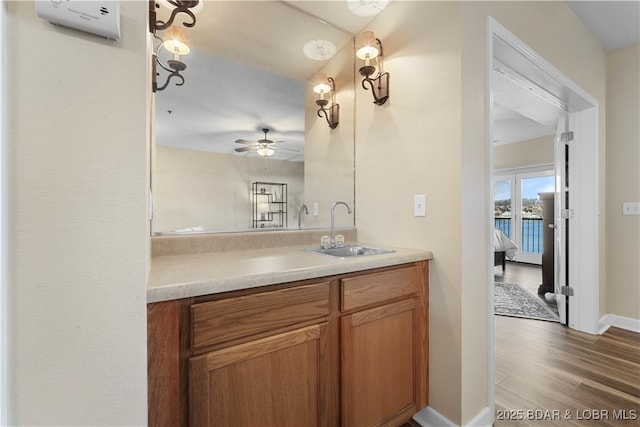 bathroom featuring vanity, wood-type flooring, and ceiling fan