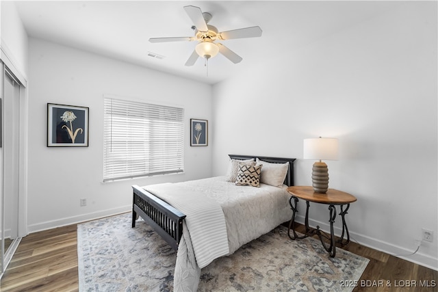 bedroom with wood-type flooring, a closet, and ceiling fan