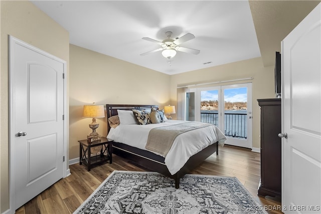 bedroom with dark hardwood / wood-style floors, access to outside, and ceiling fan