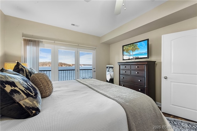 bedroom with hardwood / wood-style flooring, access to outside, and ceiling fan