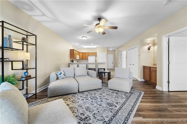 living room with dark wood-type flooring and ceiling fan