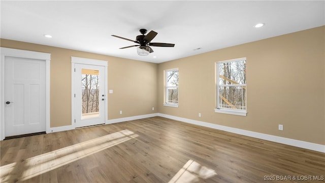 spare room with ceiling fan and wood-type flooring