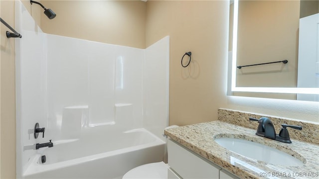 full bathroom with tub / shower combination, toilet, and vanity