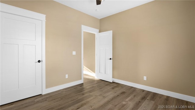 unfurnished bedroom with a closet, ceiling fan, and wood-type flooring