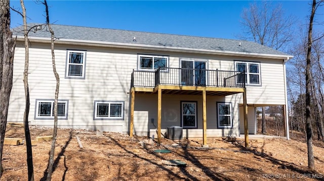 20 Simple Time Dr, Camdenton, MO 65020 - rear view of property featuring a patio, a shingled roof, central AC unit, and a balcony