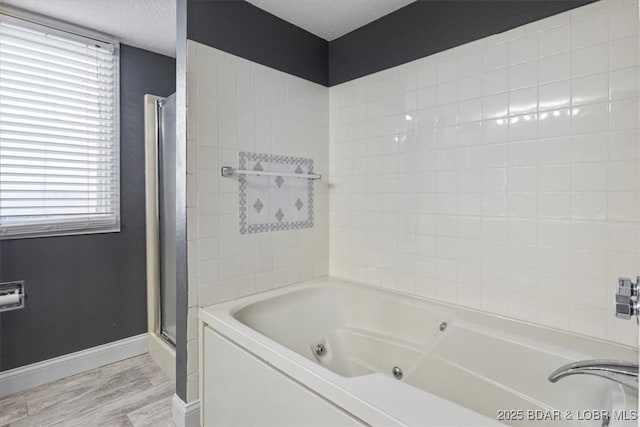 bathroom with hardwood / wood-style flooring and shower with separate bathtub