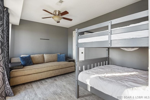 bedroom featuring wood-type flooring and ceiling fan