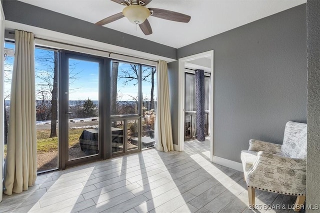 interior space with ceiling fan