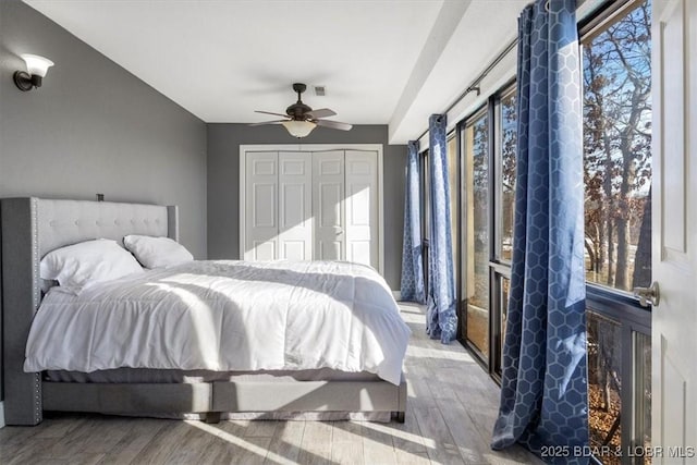 bedroom featuring hardwood / wood-style flooring, a closet, and ceiling fan