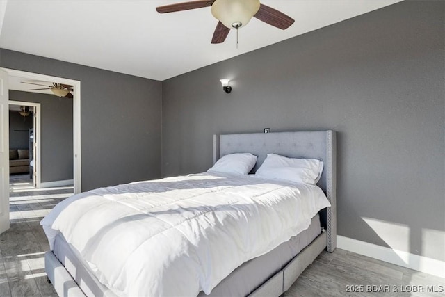 bedroom featuring ceiling fan and hardwood / wood-style floors