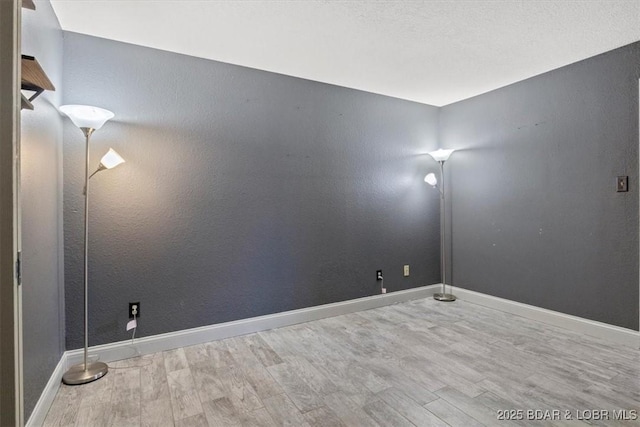 unfurnished room with light wood-type flooring