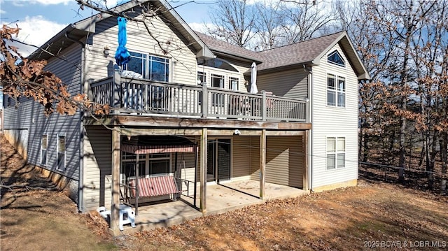 back of property featuring a deck and a patio area