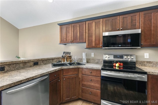 kitchen with sink and appliances with stainless steel finishes