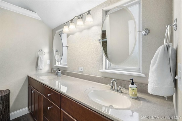 bathroom featuring vanity, vaulted ceiling, and crown molding