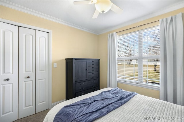 carpeted bedroom featuring a closet, ceiling fan, and ornamental molding