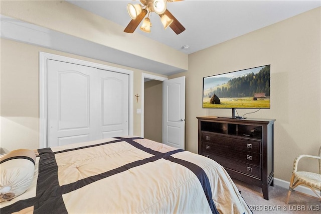 carpeted bedroom featuring ceiling fan and a closet