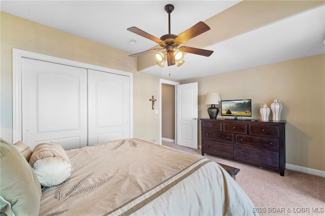 carpeted bedroom featuring a closet and ceiling fan