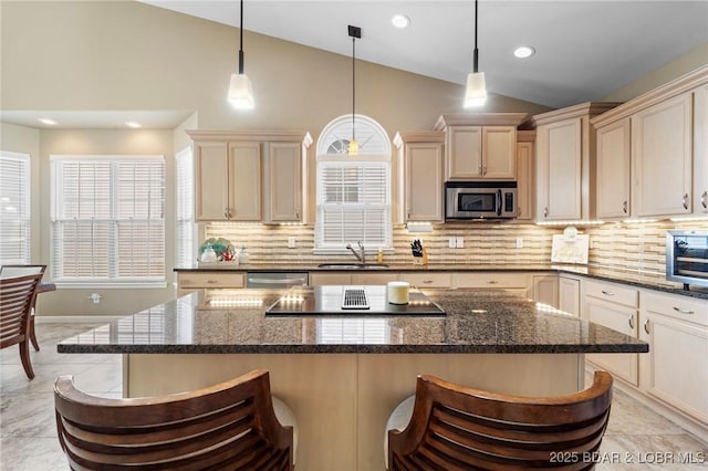 kitchen with a kitchen breakfast bar, backsplash, stainless steel appliances, and vaulted ceiling