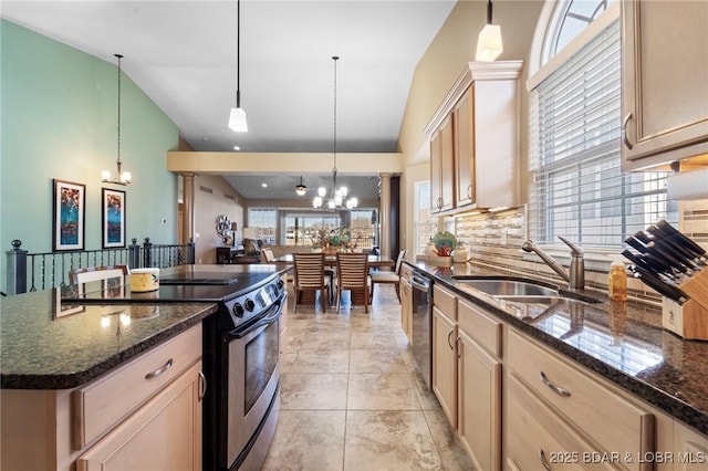 kitchen with stainless steel appliances, a center island, an inviting chandelier, and pendant lighting