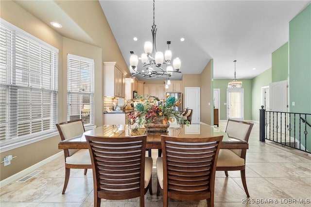 dining space with light tile patterned flooring, plenty of natural light, and vaulted ceiling