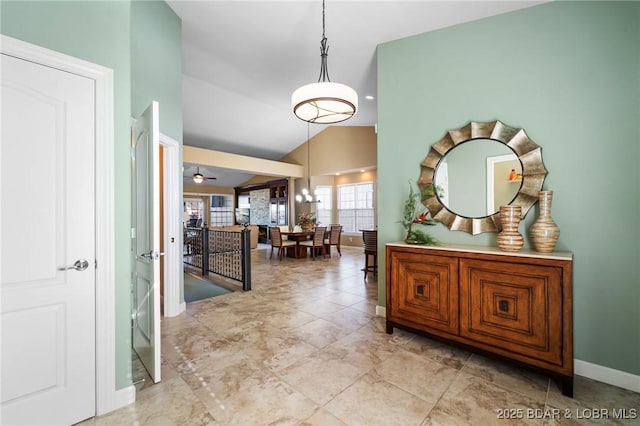 corridor featuring high vaulted ceiling