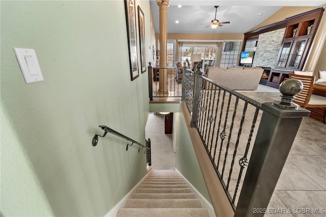 stairway featuring ceiling fan and lofted ceiling