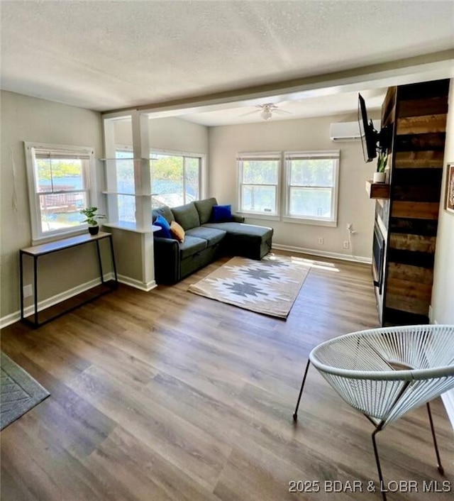 unfurnished living room featuring hardwood / wood-style flooring, a textured ceiling, and ceiling fan