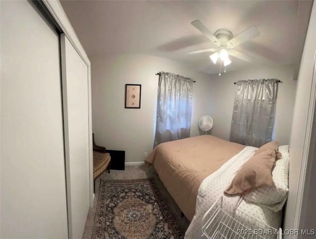 carpeted bedroom featuring a closet and ceiling fan