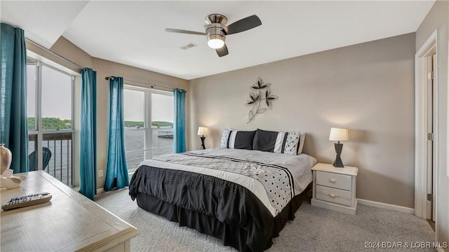 bedroom featuring light carpet, access to outside, and ceiling fan