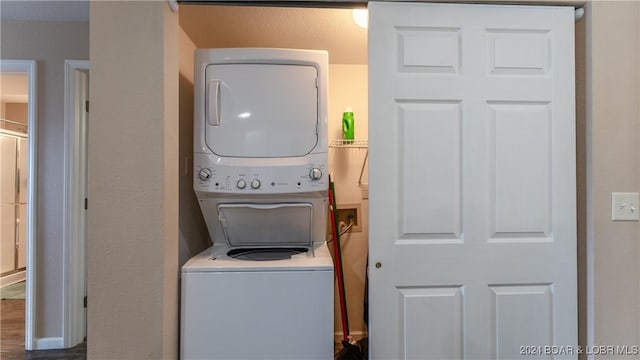 clothes washing area featuring stacked washer and dryer