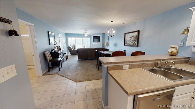 kitchen featuring dishwasher, white cabinetry, sink, and light tile patterned floors