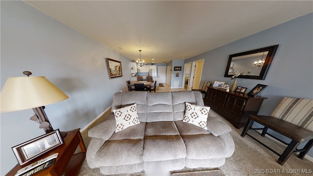 carpeted living room with a chandelier