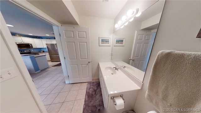 bathroom with tile patterned floors and vanity