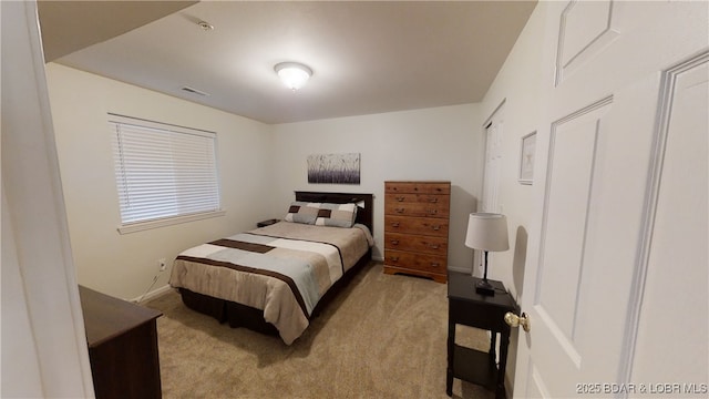 bedroom with light colored carpet