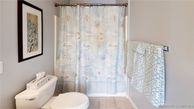 bathroom with shower / tub combo with curtain, tile patterned floors, and toilet