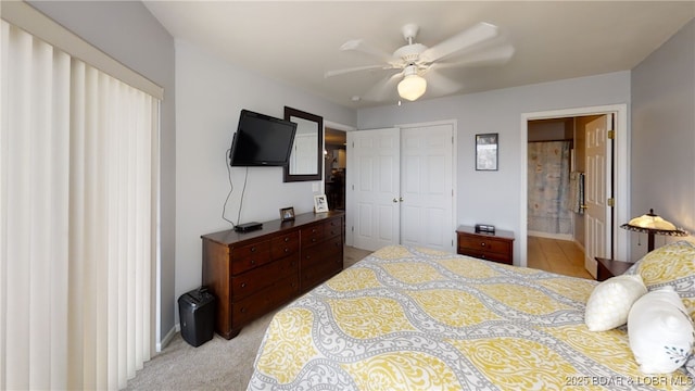 carpeted bedroom featuring ensuite bath, a closet, and ceiling fan