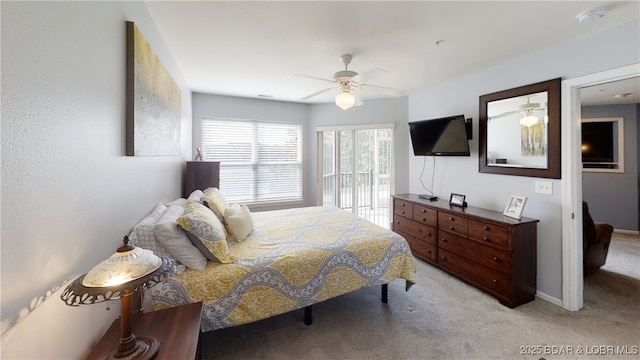 carpeted bedroom featuring ceiling fan and access to exterior