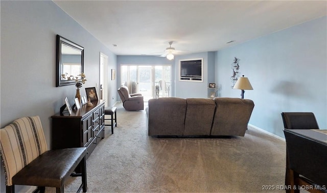 living room with ceiling fan and light colored carpet