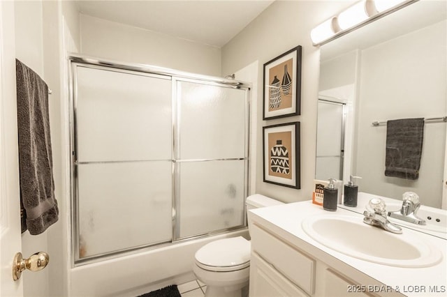 full bathroom featuring toilet, vanity, shower / bath combination with glass door, and tile patterned flooring