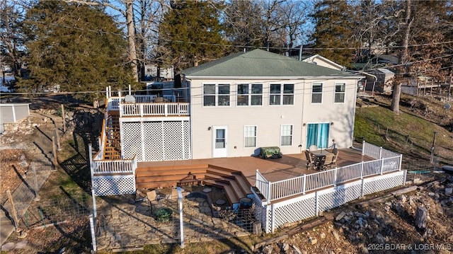 back of property with a wooden deck and a patio area