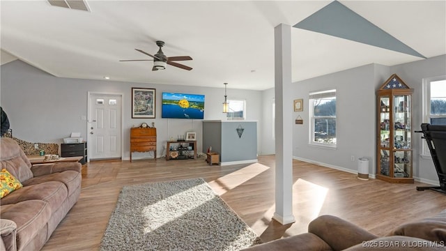 living room featuring ceiling fan and light hardwood / wood-style floors