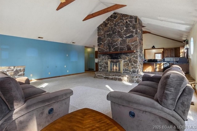 carpeted living room with vaulted ceiling with beams and a fireplace