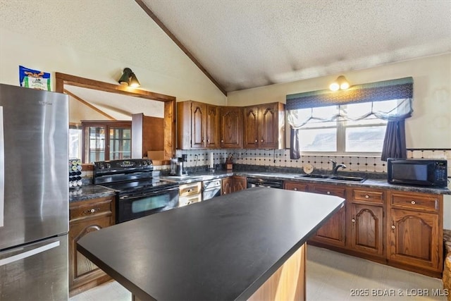 kitchen featuring vaulted ceiling, sink, backsplash, black appliances, and a textured ceiling