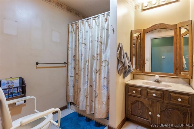 bathroom featuring a shower with curtain, tile patterned floors, and vanity