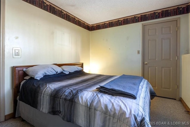 bedroom with a textured ceiling and carpet flooring